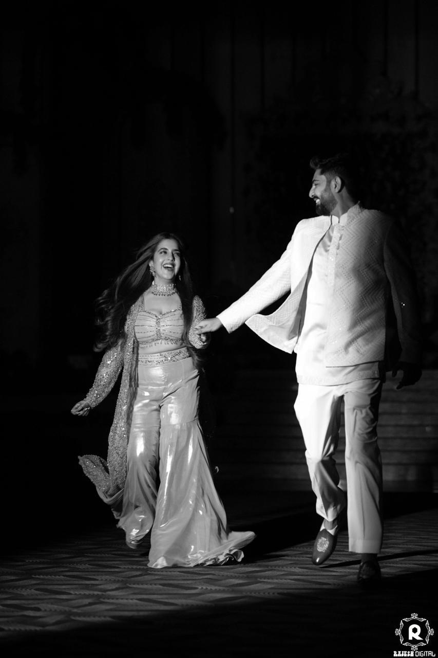 Himanshi and Anupam walking hand in hand and smiling